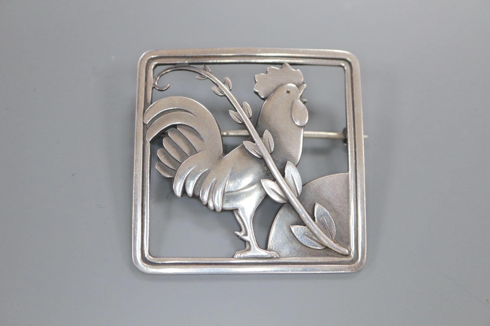 A Georg Jensen sterling Cockerel and foliate spray square brooch
